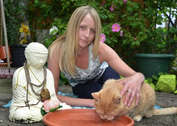 Tracie Knight with Dalai in her garden. Picture: Jon Savage