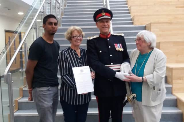 Midlothian's Lord Lieutenant Sir Robert Clerk presents the Queen's Award for Voluntary Service to the PHAB Club represented by Moira Wilson (Chair and Treasurer) Sheila Johnston (Vice Chair) and Nikhil Joshi (Volunteer Representative on the Committee and nephew of the founder of the Club, Jay Joshi).