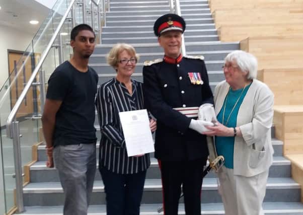 Midlothian's Lord Lieutenant Sir Robert Clerk presents the Queen's Award for Voluntary Service to the PHAB Club represented by  Moira Wilson (Chair and Treasurer) Sheila Johnston (Vice Chair) and Nikhil Joshi (Volunteer Representative on the Committee and nephew of the founder of the Club, Jay Joshi).