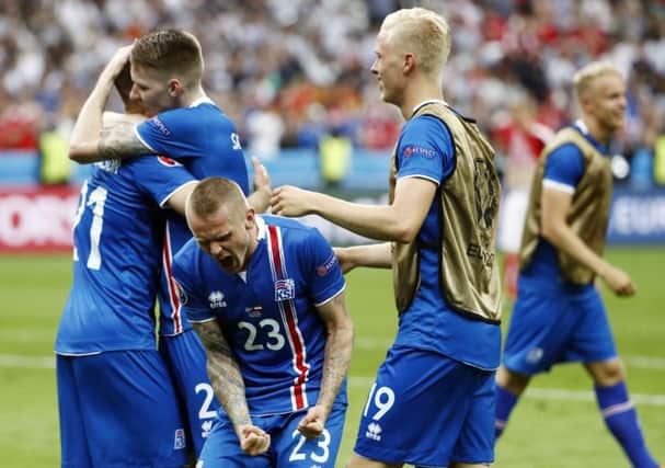 Iceland celebrate after netting their second goal against Austria, sealing qualification to the last 16. Picture: AFP/Getty