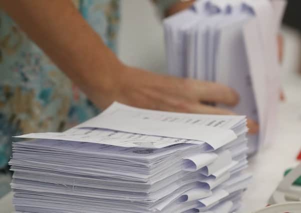 Counted ballots lie stacked on a counting table. Picture: Getty