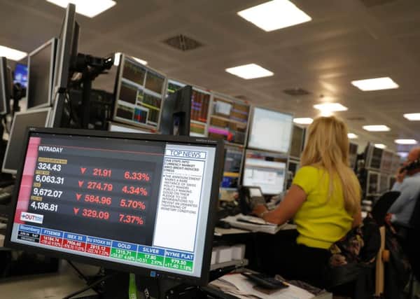 Traders fromm ETX Capital work in central london on June 24, 2015 following the announcement of the EU referendum.
 Picture: Getty Images/AFP