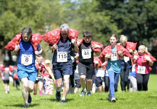 Participants run a mile carrying a sack of tatties above their shoulders.

 Picture: Lesley Martin