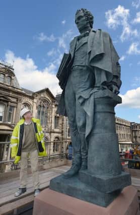 The new William Henry Playfair statue is craned into place. Picture: Neil Hanna