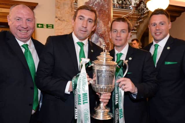 Holden, left, shows off the cup with fellow coaches Alan Stubbs, John Doolan and Alan Combe