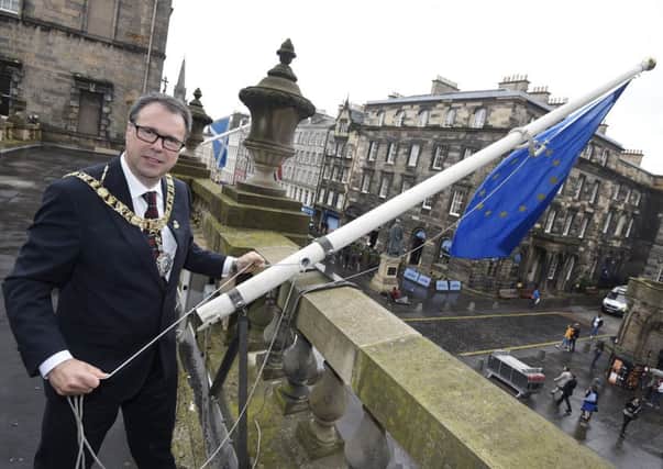Lord Provost Donald Wilson raises the European Union flag at the City Chambers. Picture: Greg Macvean