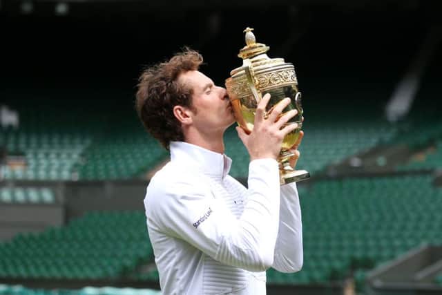 Andy Murray poses for a photograph on centre court with the the Wimbledon trophy. Picture: PA