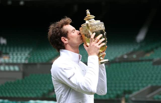 Andy Murray poses for a photograph on centre court with the the Wimbledon trophy. Picture: PA