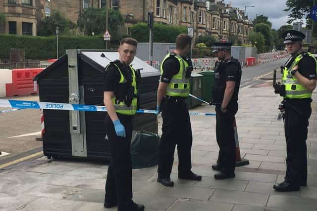 Police prepare to remove the bin from Comiston Road, Edinburgh. Picture: Comiston.co.uk