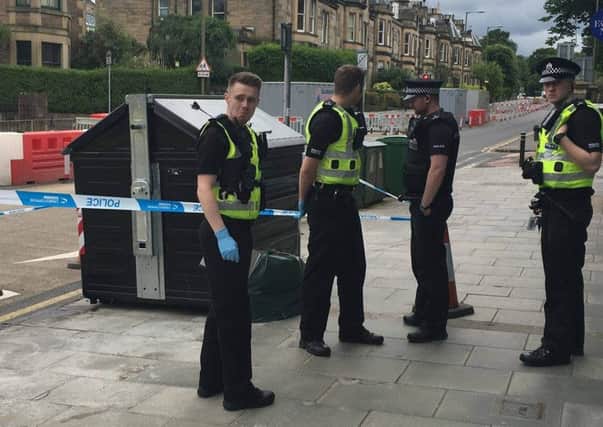 Police prepare to remove the bin from Comiston Road, Edinburgh. Picture: Comiston.co.uk