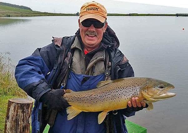 Duncan McCallum from Renton with a magnificent 13lb 8oz brown trout (C&R) taken at Woodburn Fishery.