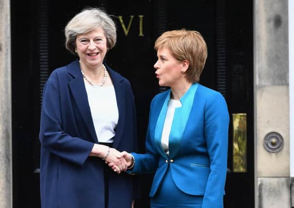 Prime Minister Theresa May meets with First Minister Nicola Sturgeon on the steps of Bute House in Edinburgh. Picture; Jeff J Mitchell/Getty Images)