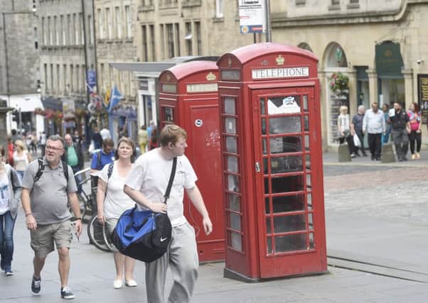 Phoneboxes on the Royal Mile by John Knox House that are being turned into office spaces with keyboards and wireless printers. Picture; Greg Macvean
