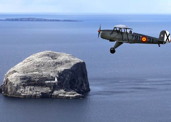 Gavin Hunter takes a practice flight in a Bucker Jungmann over the Bass Rock off the East Lothian coast ahead of his appearance at Scotland's National Airshow at East Fortune, East Lothian. Picture; Jane Barlow/PA Wire