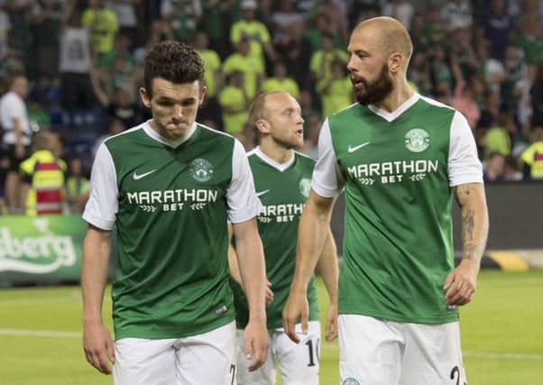 A disappointed John McGinn, left, leaves the field in Denmark with Jordon Forster and Dylan McGeouch, in background