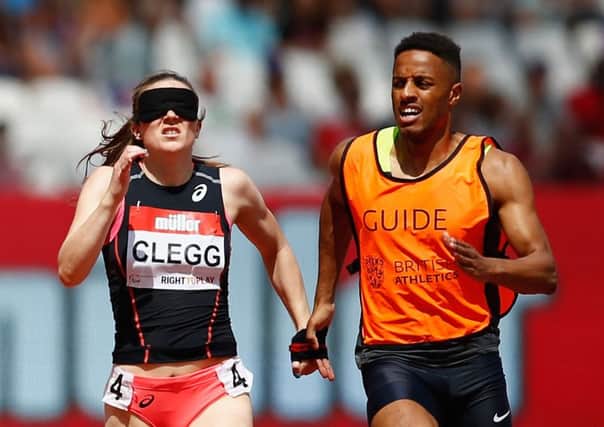 Libby Clegg wins the 200m Womens T11/12 alongside guide runner Chris Clarke