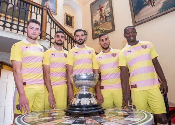Hearts players, from left, John Souttar, Igor Rossi, Alim Ozturk, Faycal Rherras and Arnaud Djoum pose in the new Hearts away kit alongside the Rosebery Cup. Pic: Ian Georgeson
