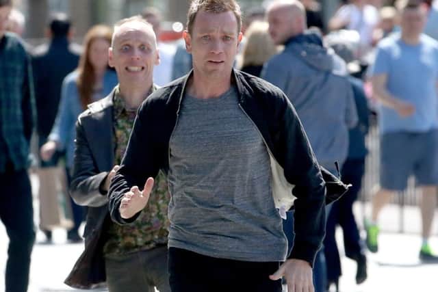 Actors Ewan McGregor (front) and Ewan Bremner (behind) running through the streets of Edinburgh where scenes for the new Trainspotting 2 is being filmed. Picture; Jane Barlow