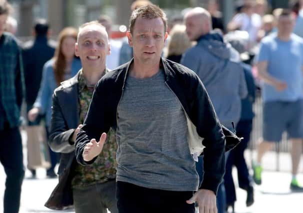 Actors Ewan McGregor (front) and Ewan Bremner (behind) running through the streets of Edinburgh where scenes for the new Trainspotting 2 is being filmed. Picture; Jane Barlow