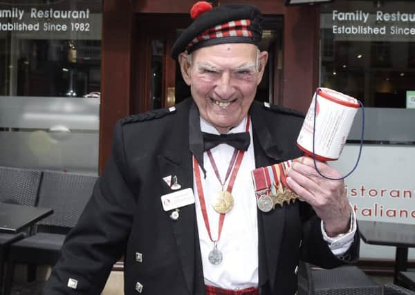 Tom Gilzean collecting on the Royal Mile. Picture: Greg Macvean