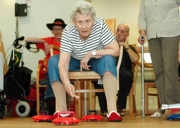 Senior olympics held at Inch View Care Home, Gilmerton, Edinburgh. Isa Soper gets into the curling. Picture Toby Williams