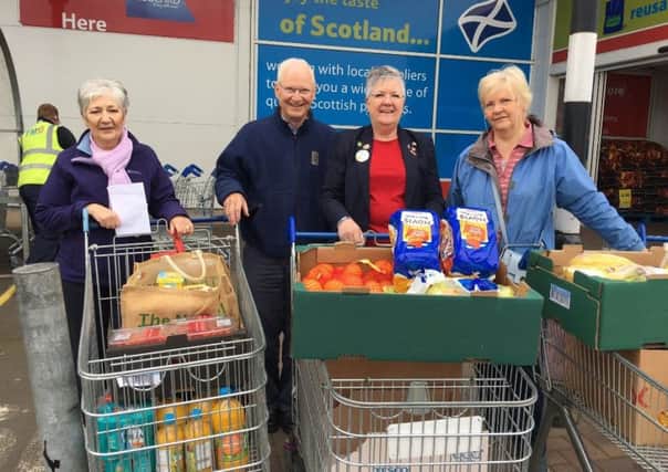 Penicuik: Volunteers from Penicuik North Kirk and a Tesco staff member with groceries. Picture; contributed