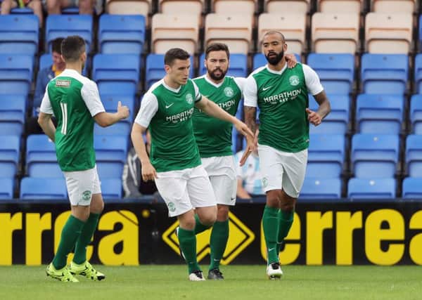 Liam Fontaine, far right, is joined by his team-mates after scoring the opener for Hibs at Shrewsbury. Pic: Matthew Ashton