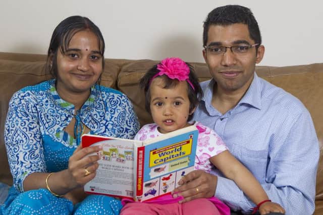 Ramesh and Kavitha Kumar with two-year-old Rakshitha. Picture: SWNS
