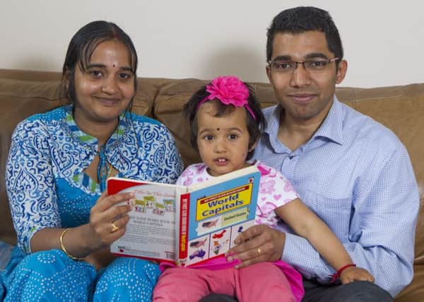 Ramesh and Kavitha Kumar with two-year-old Rakshitha. Picture: SWNS