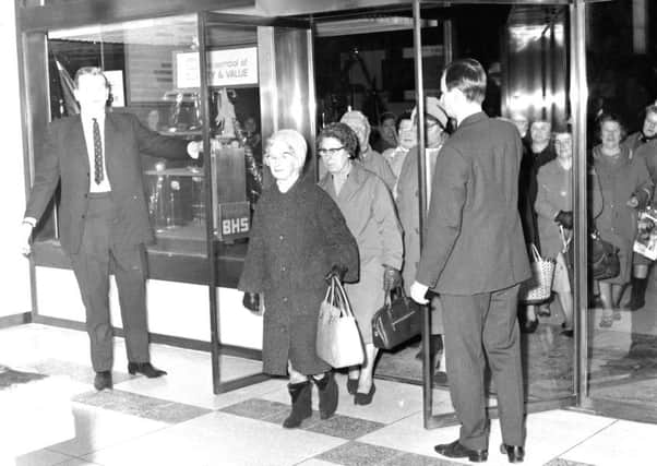 Mrs M Pearson from Bathgate is the first customer through the door as the Princes Street BHS opens in 1967. Picture: Joe Steele