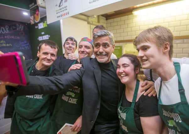 George Clooney took a selfie with staff when he visited the not-for-profit sandwich shop Social Bite. Picture: SWNS