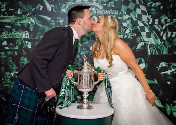 Bride and groom Sarah and Andy Cook with the Scottish Cup. Picture: Alan Gray