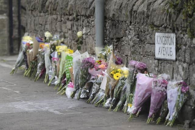Floral tributes are being left for a nurse was killed when she was hit by a car which was being chased by police in Edinburgh. Three people have been detained.  Jill Pirrie is believed to have been walking home from work. Picture; Neil Hanna