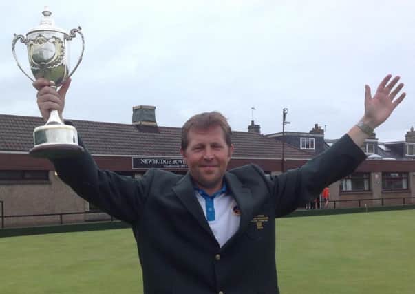 Greg Logan shows off the West Lothian Masters trophy and Green Jacket