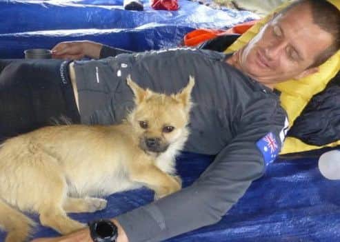 Leonard with Gobi, the stray dog who befriended him on the route of the 4 Desert Race in China.  Leonard has now launched a crowdfunding page to try and bring Gobi back to Edinburgh. Picture; Contributed