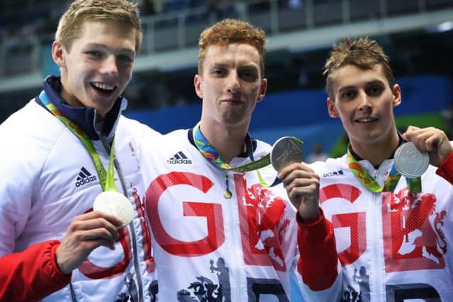 Wallace, centre, shows off his silver medal alongside Duncan Scott and Stephen Milne. Pic: Getty