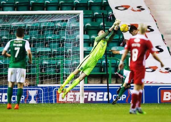John McGinn (No.7) can only watch on helplessly as Hibs goalkeeper Ross Laidlaw is beaten to the ball by Grant Anderson to make it 2-1. Pic: SNS