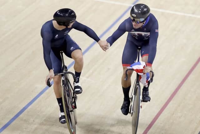 Callum Skinner, right, celebrates with Jason Kenny after winning gold in the men's team sprint finals. Picture: AP