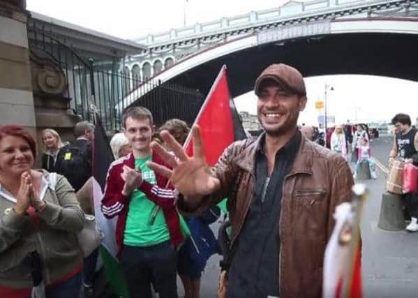 Hamde Abu Rahma arriving at Edinburgh Waverly this morning. Picture; Pat Herd