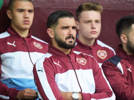 Alim Ozturk had to watch on from the subs bench against Aberdeen. Pic: SNS