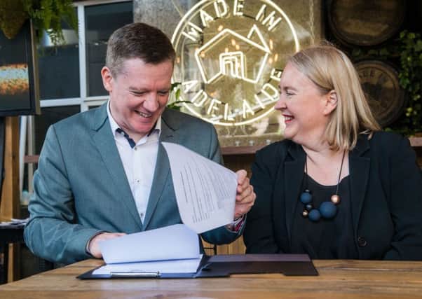 EIF director Fergus Linnehan and Rachel Healy, co-artistic director of the Adelaide Festival, agree the deal. Picture: Ian Georgeson