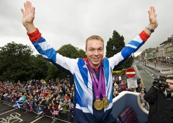 Sir Chris Hoy takes the acclaim of the crowds on the open-top bus parade following the 2012 Olympics. Picture: Ian Georgeson