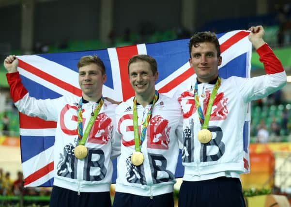 Philip Hindes, Jason Kenny and Callum Skinner celebrate after winning gold and getting an Olympic record in the Men's Team Sprint. Picture; Bryn Lennon