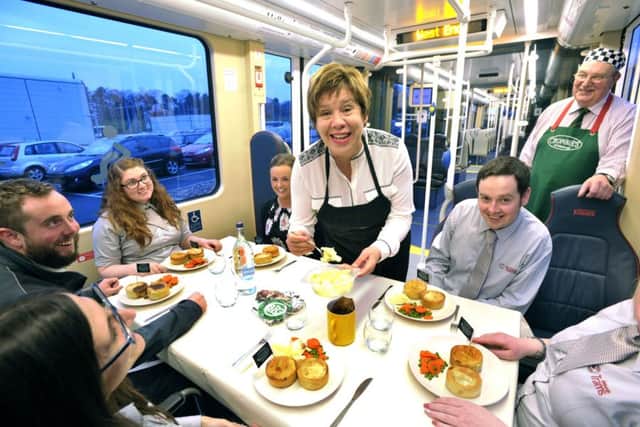Lesley Hinds and Sandy Crombie are seen here serving Crombie's scotch pies and gravy to Edinburgh Trams staff at the Gogarburn Tram depot today. Picture Ian Rutherford