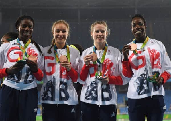 Eildh Doyle, second from the right, shows off her bronze medal alongside fellow 4x400m team 
members Christine Ohurougu, Emily Diamond and Anyika Onuora. Pic: Getty