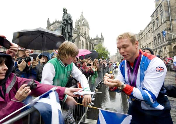 Sir Chris Hoy signs autographs for fans on the Royal Mile during Edinburgh's 2012 celebrations. Picture: Ian Georgeson