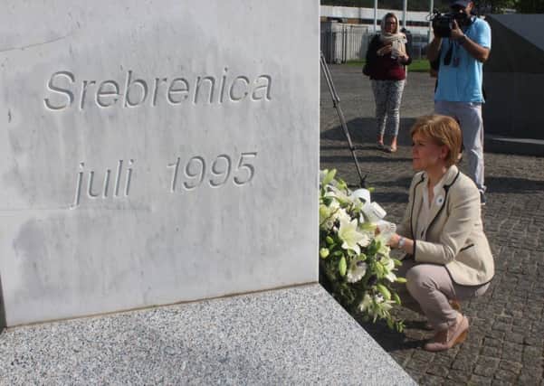 First Minister Nicola Sturgeon lays flowers at a monument to the victims of Srebrenica. Picture: PA