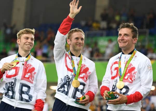 Gold medalists Britain's Philip Hindes, Jason Kenny and Callum Skinner pose on the podium with their medals. Picture;  Greg Baker