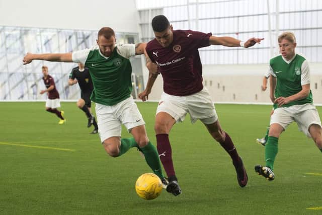 Hibs' Jordon Forster and Hearts' Bjorn Johnsen tussle for possession. Pic: SNS
