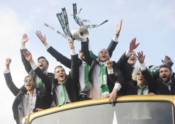 Hibernian make their way from the Royal Mile in an open top bus to Leith Links to parade the Scottish Cup. Picture; Greg Macvean